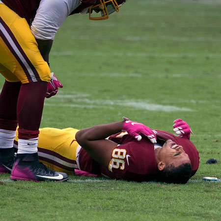 Injured football player on the field - Sports Injury